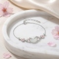 wholesale 925 Sterling Silver Elegant Silver Bracelet Featuring Pink Enamel Flowers and a White Jade Donut Center. - JewelryODM-0-2