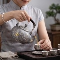 wholesale 999 Pure Silver Handcrafted Repoussé Silver Teapot with Shimmering Mountain Landscapes and Rattan-Wrapped Handle - Handicraft-0-3