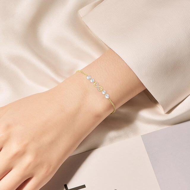 Armband mit Anhänger „Unendlichkeitssymbol“ aus 10 Karat Gold mit Diamanten und Perlen-1
